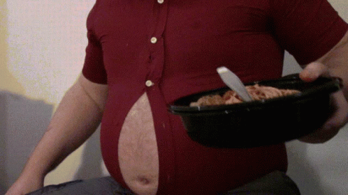 A Man With A Large Belly Is Holding A Bowl Of Food With A Knife In It GIF