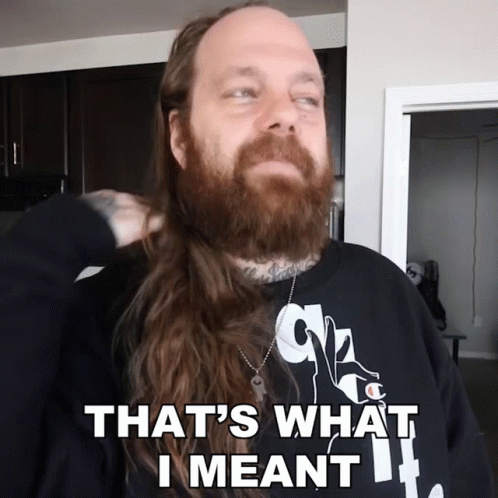 a man with a long beard is wearing a shirt that says that 's what i meant