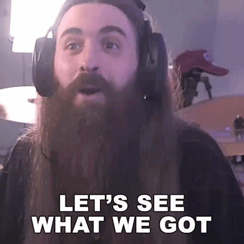 A Man With A Long Beard Wearing Headphones Says Let 'S See What We Got GIF