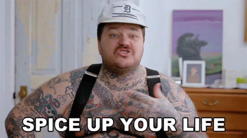 A Man With A Lot Of Tattoos Has The Words Spice Up Your Life On His Chest GIF