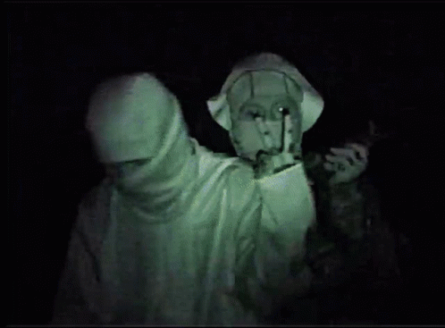 A Man With A Mask On His Face Is Giving The Peace Sign GIF