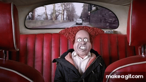 A Man With A Mask On His Face Is Sitting In A Car GIF