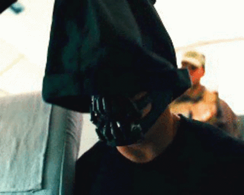 A Man With A Mask On His Face Is Sitting On A Plane GIF