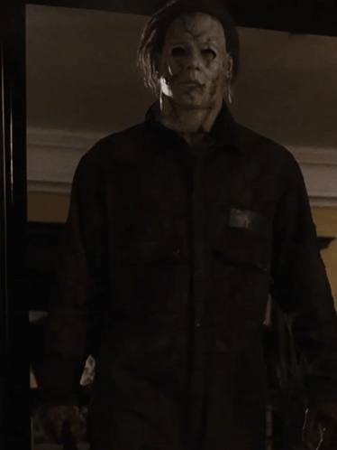 a man with a mask on his face is wearing a shirt and tie
