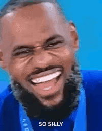 A Man With A Medal Around His Neck Is Laughing And Smiling . GIF