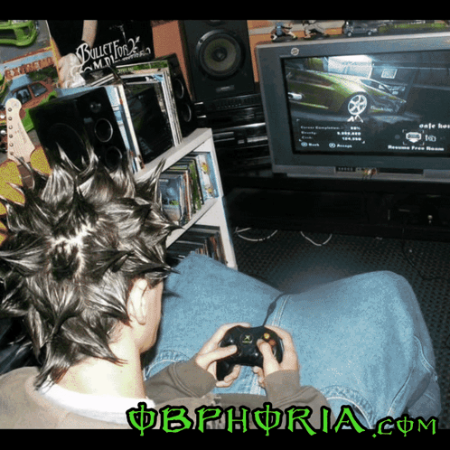 A Man With A Mohawk Is Playing A Video Game With The Website Obphoria.com Visible In The Corner GIF