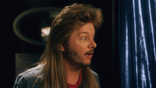 A Man With A Mullet And A Beard Is Making A Surprised Face GIF