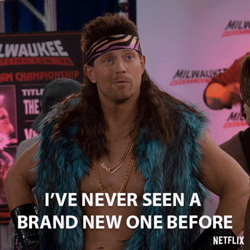 A Man With A Mullet Is Standing In Front Of A Sign That Says Milwaukee GIF