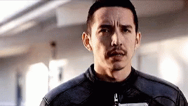 A Man With A Mustache And A Leather Jacket Is Looking At The Camera . GIF