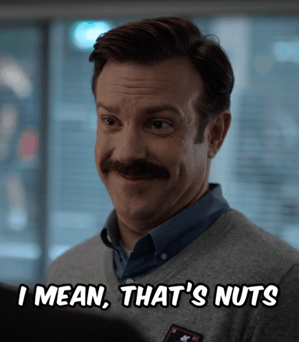 A Man With A Mustache And A Sweater That Says I Mean That 'S Nuts GIF