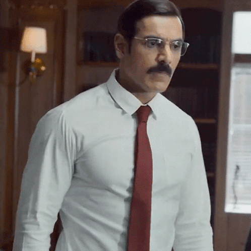 A Man With A Mustache And Glasses Wearing A White Shirt And Red Tie GIF