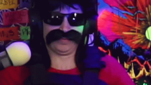 A Man With A Mustache And Sunglasses Is Standing In Front Of A Colorful Wall . GIF