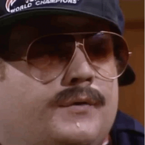 A Man With A Mustache And Sunglasses Is Wearing A Baseball Cap And Sunglasses . GIF