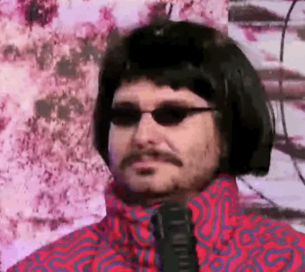 A Man With A Mustache And Sunglasses Is Wearing A Wig And Tie . GIF