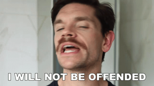 A Man With A Mustache Has His Eyes Closed And Says " I Will Not Be Offended " GIF