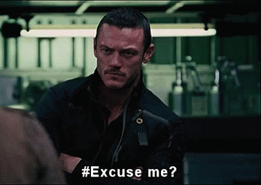 A Man With A Mustache Is Asking Someone To Excuse Him . GIF