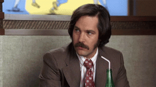 A Man With A Mustache Is Drinking Through A Straw . GIF