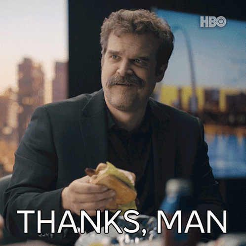 A Man With A Mustache Is Eating A Sandwich With The Words Thanks Man Written Below Him GIF