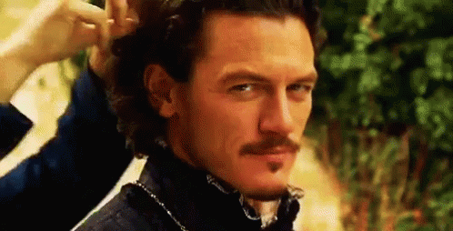 A Man With A Mustache Is Getting His Hair Done . GIF