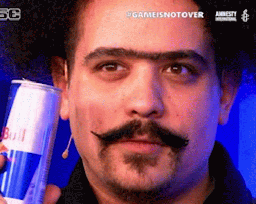 A Man With A Mustache Is Holding A Can Of Redbull GIF