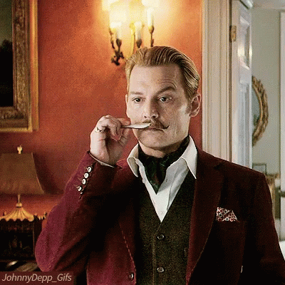 A Man With A Mustache Is Holding A Spoon In His Mouth And The Name Johnny Depp Is On The Bottom GIF