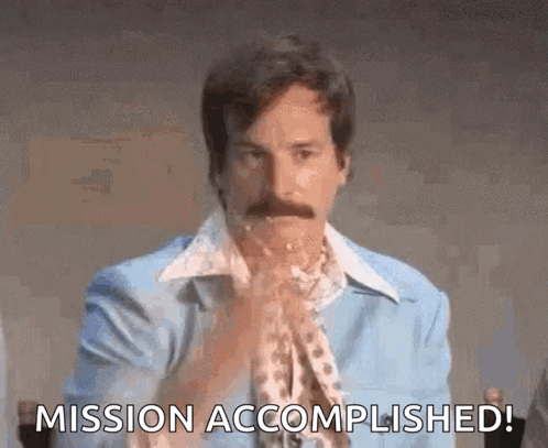 A Man With A Mustache Is Holding His Hands Together And Saying Mission Accomplished ! GIF