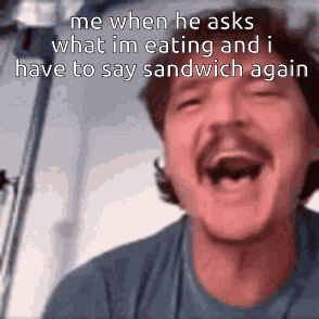 A Man With A Mustache Is Laughing With His Mouth Open GIF