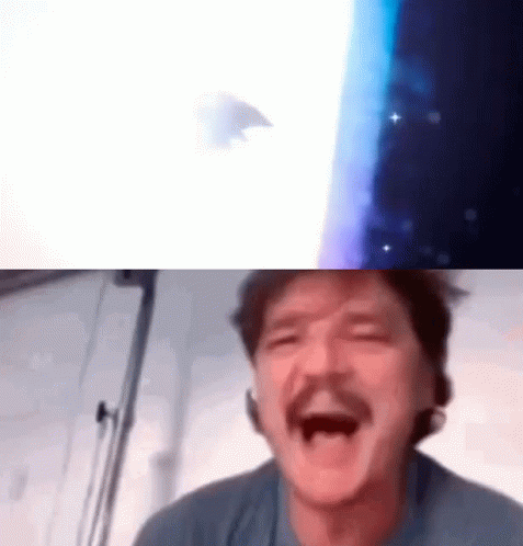 A Man With A Mustache Is Laughing With His Mouth Open In Front Of A Screen . GIF