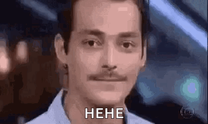 a man with a mustache is making a funny face and saying , `` heh '' .