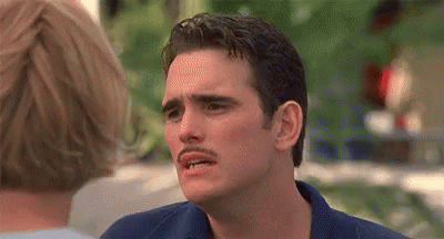 A Man With A Mustache Is Making A Funny Face In Front Of A Woman . GIF
