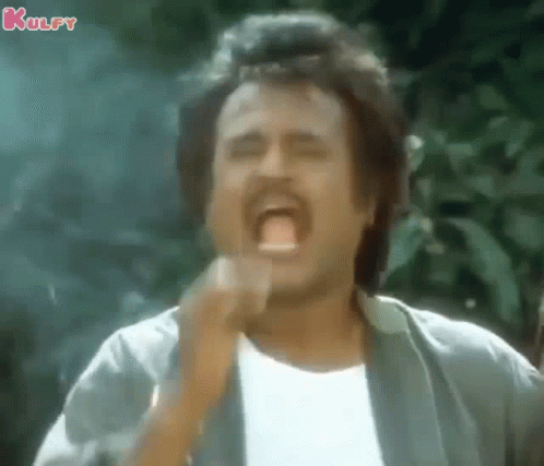 A Man With A Mustache Is Making A Funny Face With His Mouth Open And His Hand In His Mouth . GIF