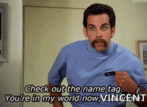 A Man With A Mustache Is Saying Check Out The Name Tag You 'Re In My World Now GIF