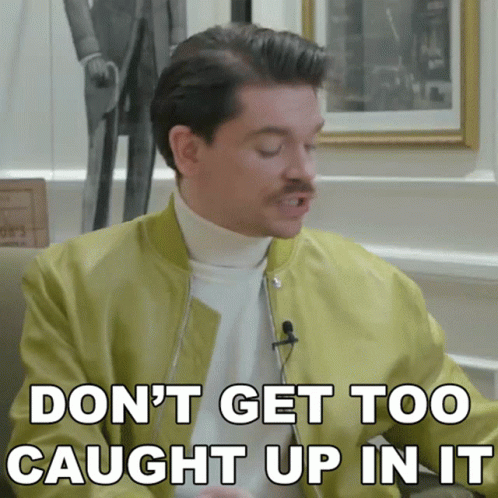 A Man With A Mustache Is Saying " Don 'T Get Too Caught Up In It " GIF