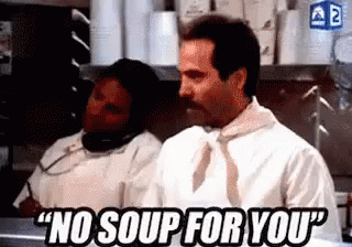 A Man With A Mustache Is Saying `` No Soup For You '' While Standing In A Kitchen Next To A Woman . GIF