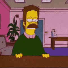 A Man With A Mustache Is Sitting At A Desk GIF