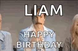 A Man With A Mustache Is Sitting In Front Of A Group Of People . GIF