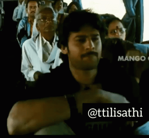 A Man With A Mustache Is Sitting On A Bus With Other People .. GIF