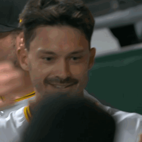 Smiling Man With Mustache Looking At Something GIF