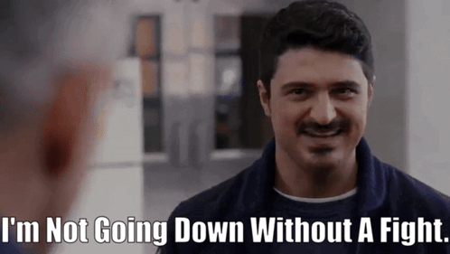 A Man With A Mustache Is Smiling And Says I 'M Not Going Down Without A Fight GIF