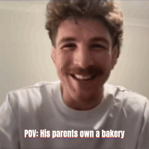 A Man With A Mustache Is Smiling With The Caption " Pov : His Parents Own A Bakery " Above Him GIF