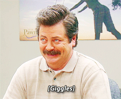 A Man With A Mustache Is Smiling With The Word Giggles On His Shirt GIF
