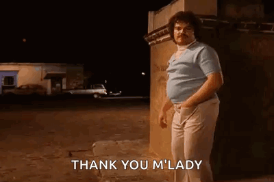 A Man With A Mustache Is Standing In Front Of A Building At Night And Saying `` Thank You M ' Lady '' . GIF