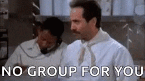 A Man With A Mustache Is Standing In Front Of A Sign That Says No Group For You . GIF