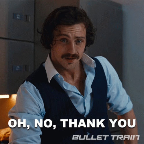 A Man With A Mustache Is Standing In Front Of A Sign That Says Oh No Thank You Bullet Train GIF
