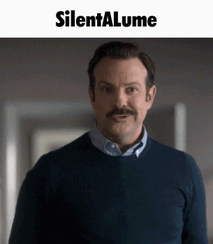 A Man With A Mustache Is Standing In Front Of A Silenta Lume Sign GIF