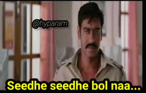 A Man With A Mustache Is Standing In Front Of A Window With A Caption That Says Seedhe Seedhe Bol Naa . GIF