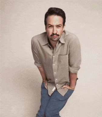 A Man With A Mustache Is Standing With His Hands On His Hips GIF