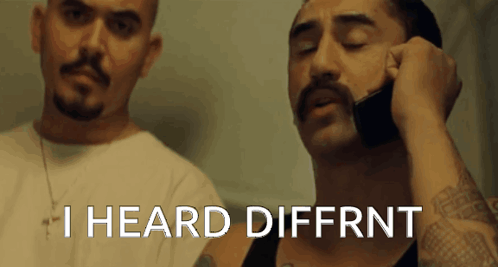 A Man With A Mustache Is Talking On A Cell Phone With The Words I Heard Diffrnt Above Him GIF