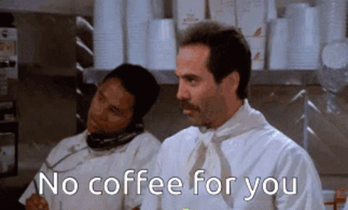 A Man With A Mustache Is Talking On A Phone While Another Man Says No Coffee For You GIF