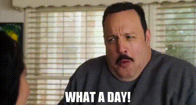 A Man With A Mustache Is Talking To A Woman In Front Of A Window . GIF